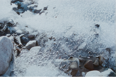 Shot of partially-broken ice in a dry frozen river.