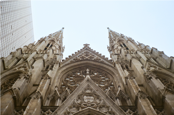 Shot of top of cathedral against the blue sky.