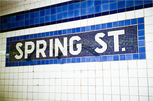 Blue and white tiles spell out Spring Street, for the metro station.