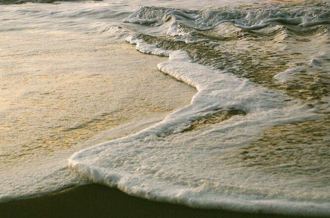 Evening shot of the waves receding on the beach.