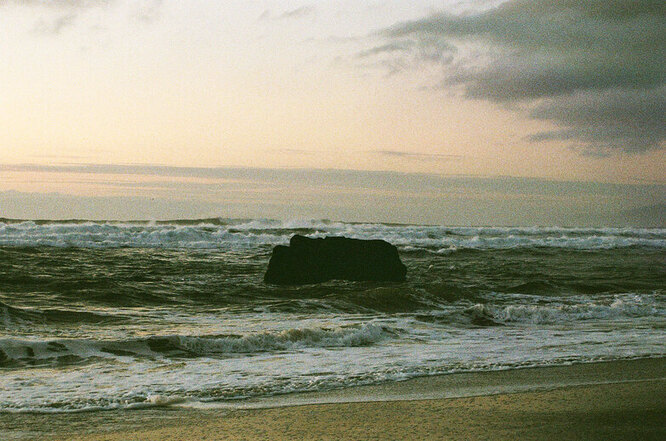 Evening shot of a rock in the ocean.